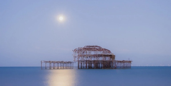 Brighton West Pier Ruins Victorian cast-iron skeleton sunset silhouette against English Channel