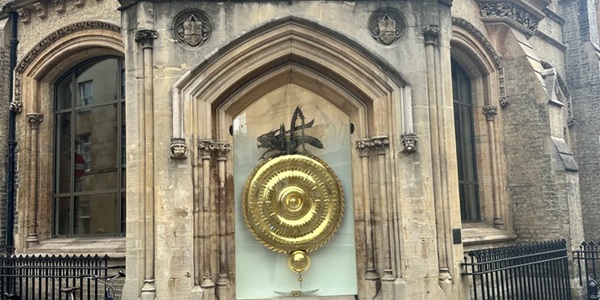 Corpus Clock gold-plated disc and Chronophage grasshopper sculpture on Cambridge street