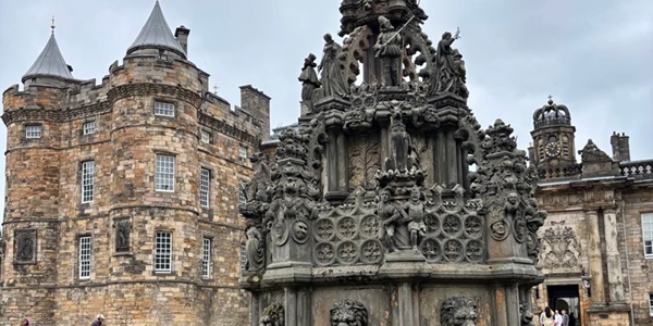 Panoramic view of the Baroque Palace of Holyroodhouse with Gothic columns of the abbey ruins