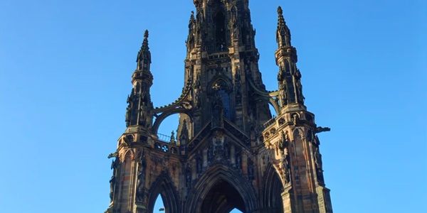 Panoramic view of the Scott Monument Gothic spire and white marble seated statue of Sir Walter Scott