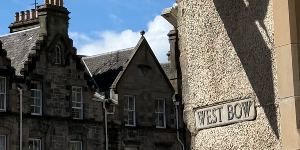 Panoramic view of Victoria Street's curved street and rainbow-coloured bow-fronted shops