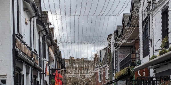 Glasgow Ashton Lane cobblestone street with fairy lights at night