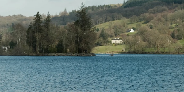 Coniston Water with steam yacht Gondola and reflection of the Old Man of Coniston