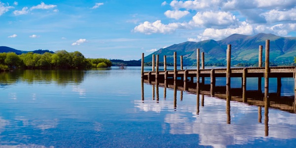 Derwentwater with boat and Catbells ridge reflected in the lake