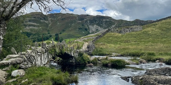 Slater's Bridge stone slab bridge over River Brathay with Langdale Valley