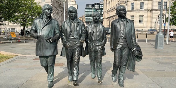Liverpool Pier Head Beatles Statue with Three Graces skyline along the Mersey