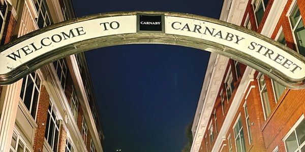 Carnaby Street London rainbow arch entrance and trendy shops