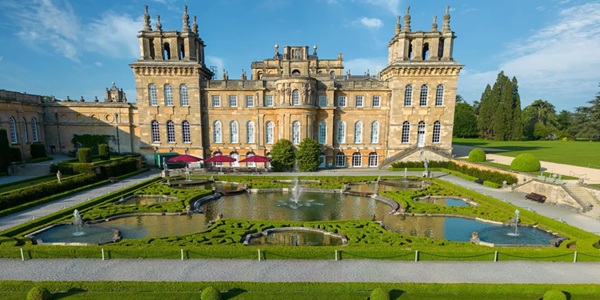 Blenheim Palace Baroque facade with Capability Brown landscaped gardens and lake